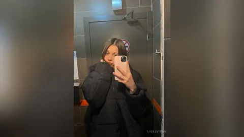 LucileVerlin — LucileVerlin takes a mirror selfie wearing a thick black puffer jacket.