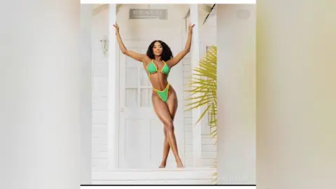 Fit Black woman in a lime green bikini posing confidently in front of a white beach house door.