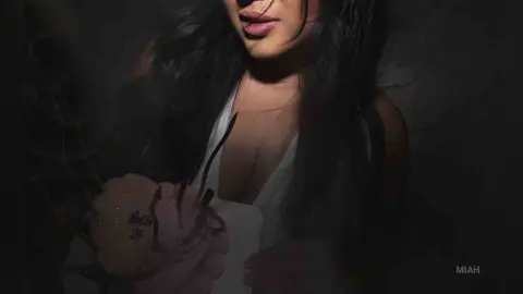 Moody portrait of a woman in a white dress holding a pink cake in a dark, atmospheric setting.