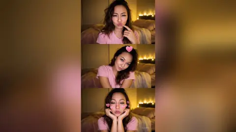 Playful young woman in a pink shirt making cute faces in a cozy, dimly lit bedroom setting.