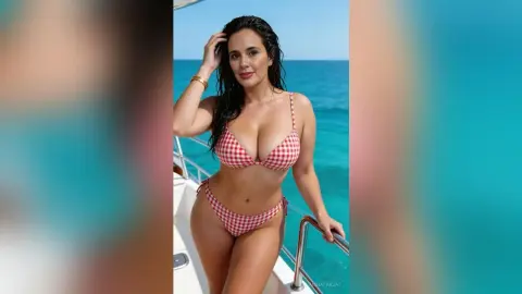 Smiling woman in red checkered bikini relaxing on a boat in the sunny turquoise ocean.