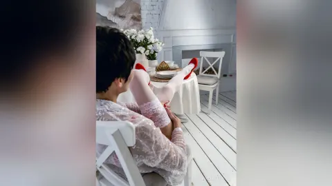 NancyTipped — NancyTipped sits at a white table wearing a sheer lace outfit and white thigh-high stockings with red heels.