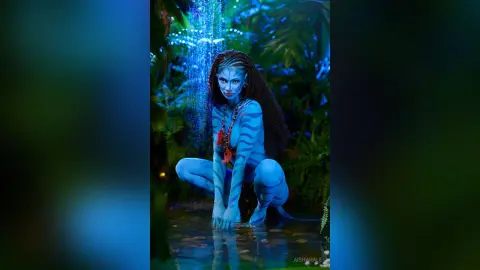 Blue skin Na'vi woman in tribal jewelry sitting by a mystical jungle waterfall in a dreamy fantasy setting.