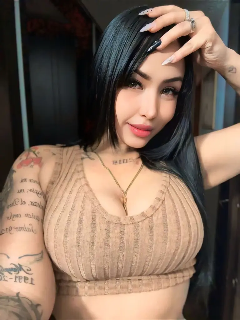 Gabilicious25 poses with her long black hair, wearing a light blue bra while showing her bare shoulders and arms against a plain white background.