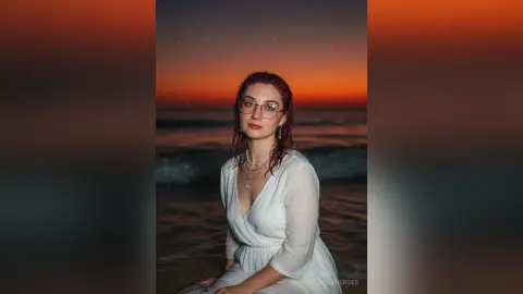 Young woman in a white summer dress smiling at the beach during a dreamy sunset.