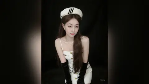 Elegant woman in a white sailor-style outfit and hat posing against a black background with a chic mood.