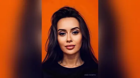 Portrait of a brunette woman with glamorous makeup posing against a vibrant orange background.