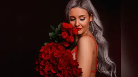 Anita holds a large bouquet of red roses against her chest, looking down with her long silver hair flowing down her back.