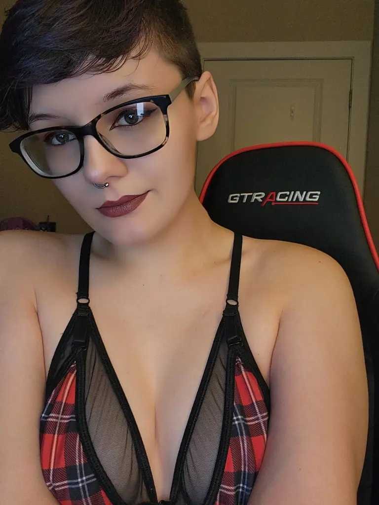 BarelyOlivia shows her face and short green hair, looking directly at the camera with a soft expression.
