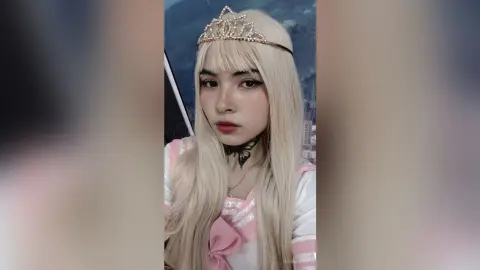 Blonde girl in pink princess cosplay wearing a gold tiara and black choker with a dreamy aesthetic.