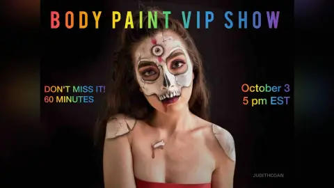 Woman with skull face paint and body art makeup for a spooky October body paint VIP show.