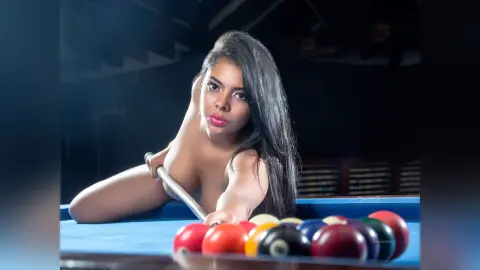 Anieminori poses naked at a pool table, leaning over blue felt with a pool cue in her hand.