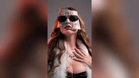 Glamorous woman in a white faux fur coat and jewelry wearing US dollar bills as sunglasses for a wealthy aesthetic.
