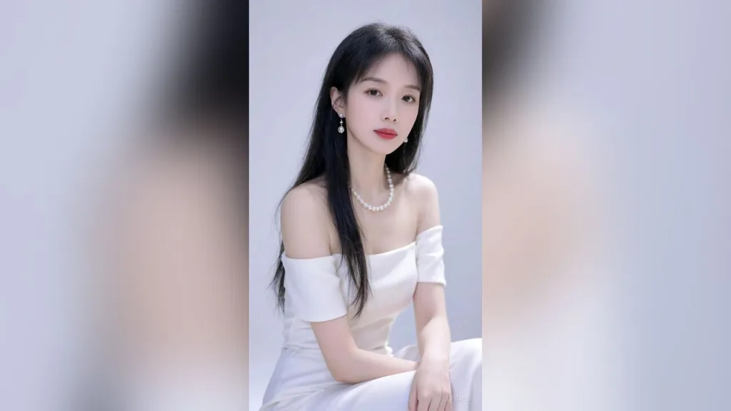 liyufei — liyufei wears a white off-the-shoulder dress and pearl necklace while posing against a light background.