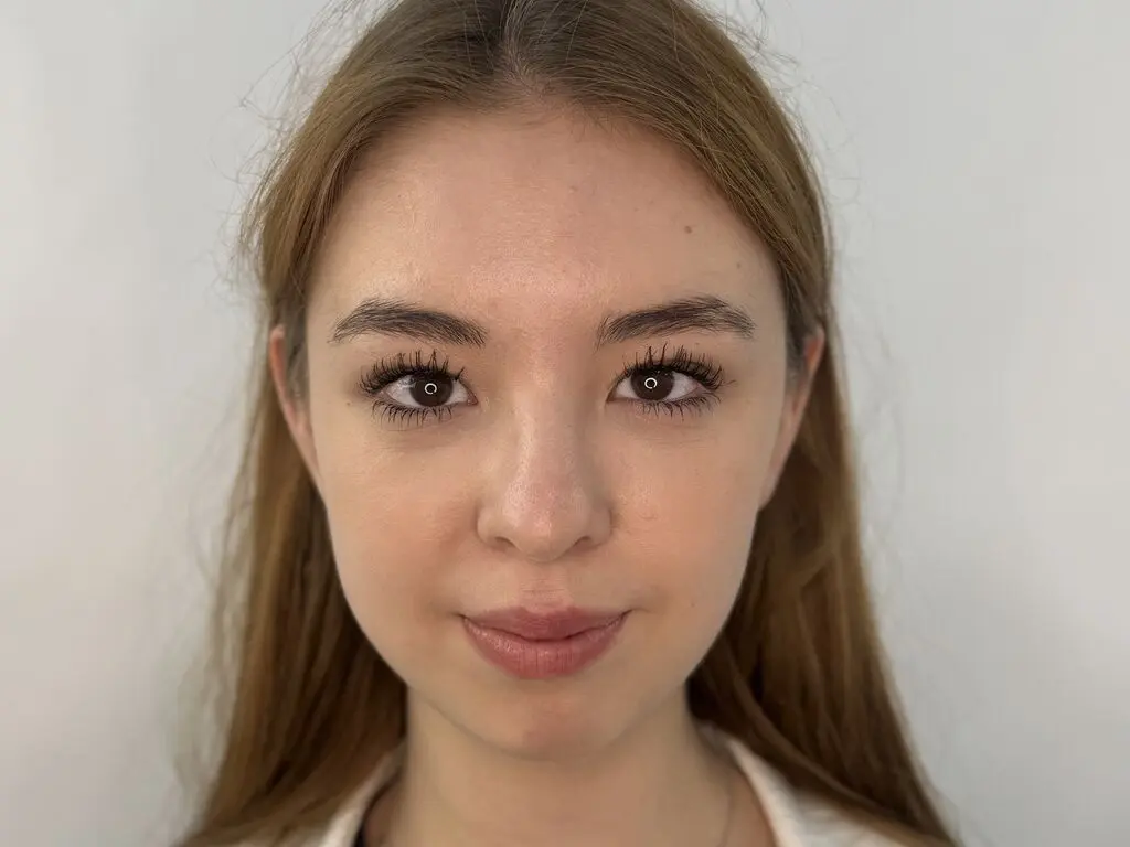 PaulettaRerucha looks directly at the camera with a neutral expression, showing her face and light brown hair against a plain white background.