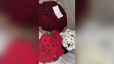 Large bouquet of fresh red roses and white daisies in a romantic floral arrangement.