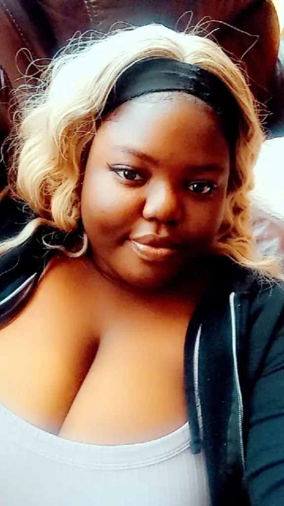 GoddessAthenaXx shows her face and blonde hair while looking directly at the camera in a close-up shot.