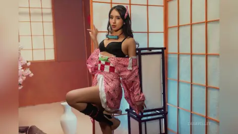 Young woman in a pink patterned kimono and black bikini posing in a traditional Japanese room with shoji screens.