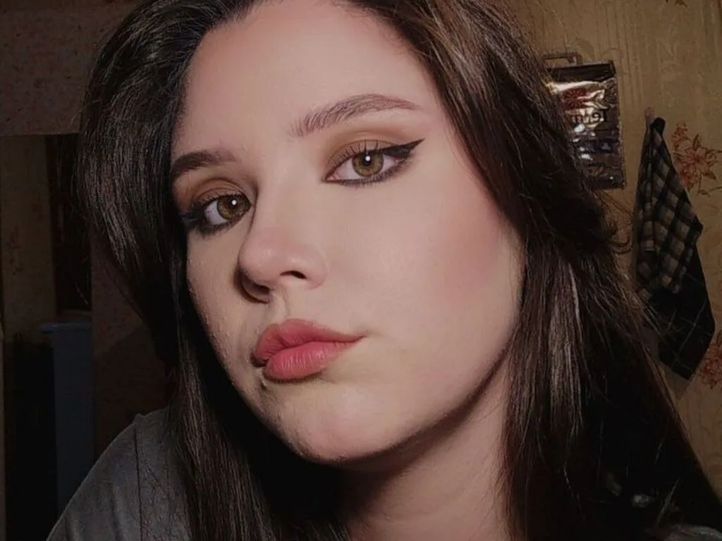 GarnettZagorski looks into the camera with winged eyeliner and long brown hair.