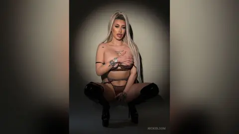 ViviAnne — NickiBloom poses in brown lace lingerie and black thigh-high boots against a dark background.