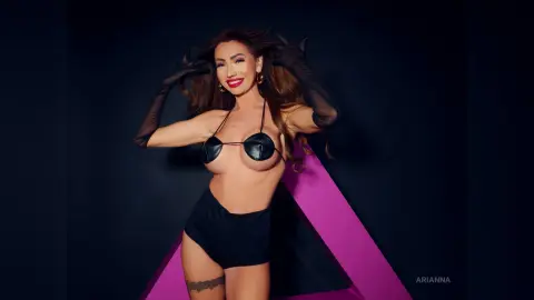 Glamorous woman in black lingerie and sheer gloves posing against a dark background with pink geometric accents.