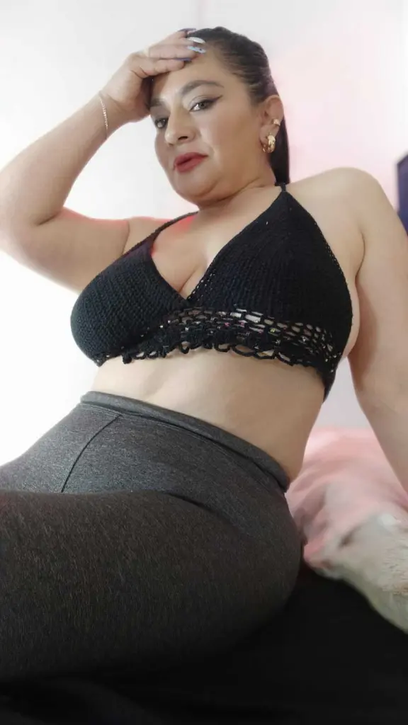 camiangel69 poses for a close-up selfie with her dark hair down and a hand resting under her chin.