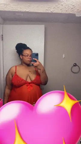 MilfArie22 poses in a red lace camisole with thin straps, wearing glasses and showing her hair in a dark updo while taking a mirror selfie.