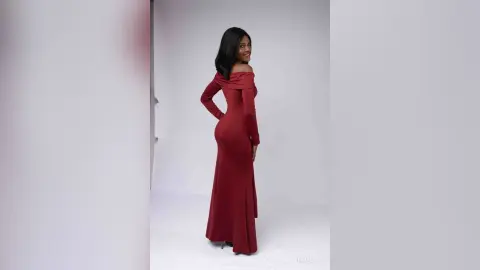 Elegant woman in a long red off-the-shoulder evening gown posing against a white studio background.