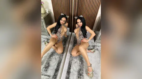 Glamorous woman in a leopard print bodysuit and cat ears posing in a modern room.