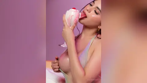ValeryRouge licks a white cream or liquid off her finger while wearing a light-colored mesh bodysuit.