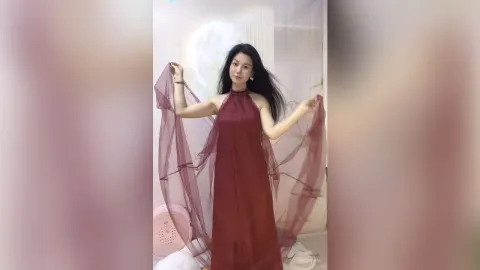 KireliaYan — KireliaYan poses in a long maroon halter dress while holding out her sheer flowing fabric.