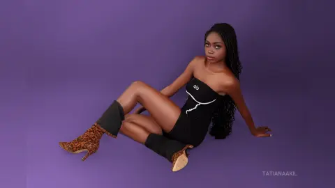 Elegant woman in a black strapless mini dress and leopard print boots sitting against a purple background.