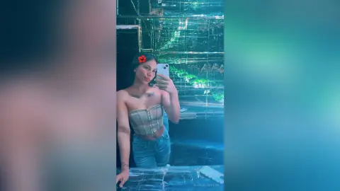 Young woman in a beige corset and blue jeans taking a selfie in a moody, neon-lit nightclub setting.