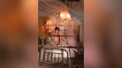 Young woman in white lace lingerie relaxing on a dreamy canopy bed in a warm, romantic bedroom setting.