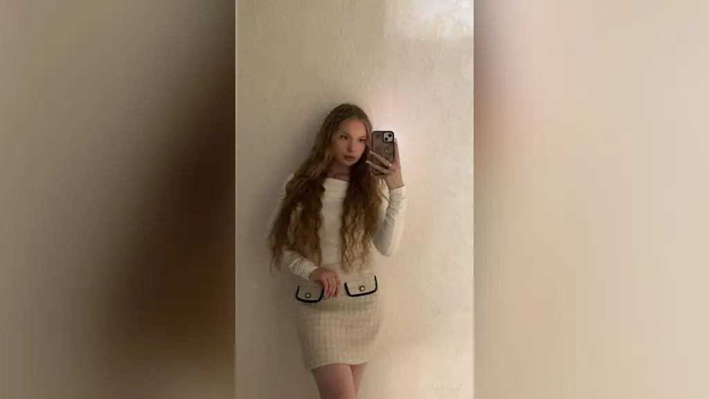 ViolaFausel poses with her long blonde hair, wearing a silver bracelet and looking directly at the camera.