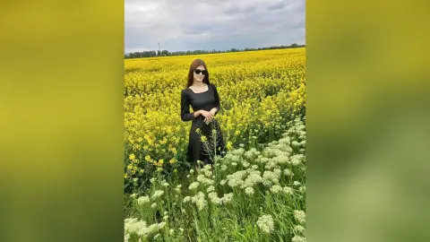 JennyStormy — Lady in black in a rapeseed field