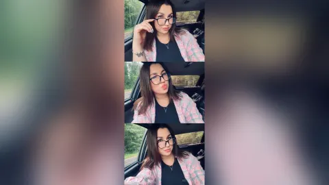 BettyBlossom — BettyBlossom wears glasses and a pink plaid shirt while sitting in a car.