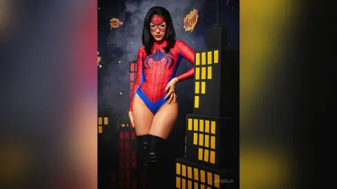 JessieLiu poses in a red and blue Spider-Man bodysuit with long black hair against a dark, starry background.