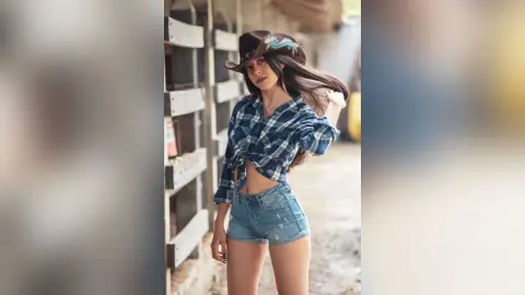 JessieLiu wears a blue plaid button-down shirt tied above her waist and denim shorts with a brown cowboy hat.