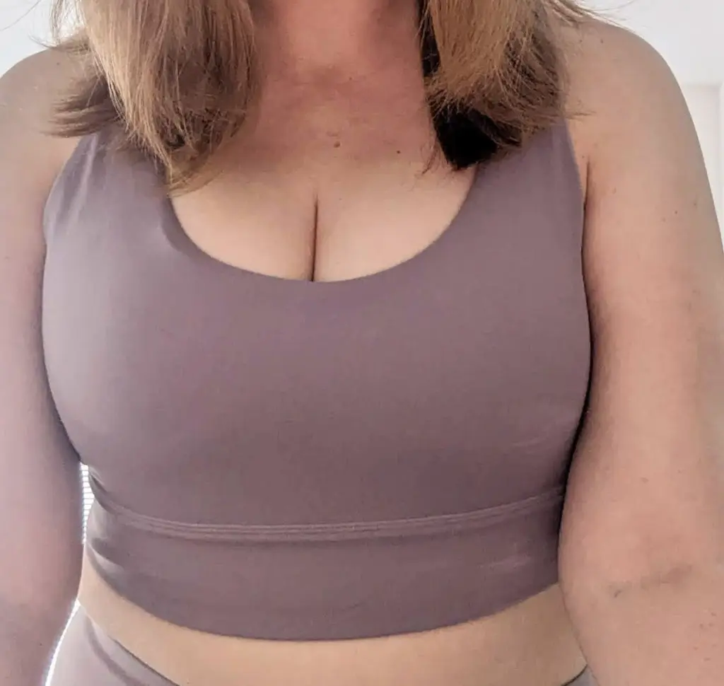 CharlotteBelleX shows her blonde hair and cleavage while wearing a black v-neck top.