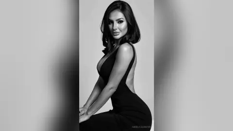 Elegant woman in a black evening gown posing for a sophisticated black and white studio portrait.