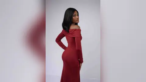 Elegant woman in a long-sleeved burgundy off-the-shoulder gown posing against a minimalist white studio background.