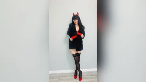 ViolaWin — ViolaWin wears a black devil costume with red accents, red horns, and black stockings while posing against a plain wall.