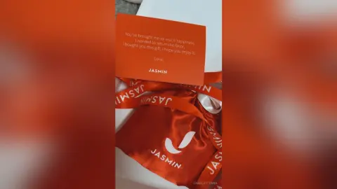 Personalized white gift box with a red satin ribbon and a heartfelt handwritten note from Jasmin.