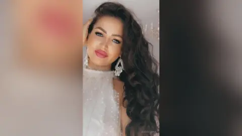 Glamorous woman in a white sequined halter dress with elegant wavy hair and statement earrings.