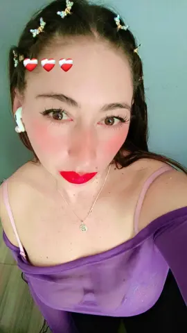 LunaMaren looks at the camera wearing a sheer purple top and a silver necklace, showing her face and chest.