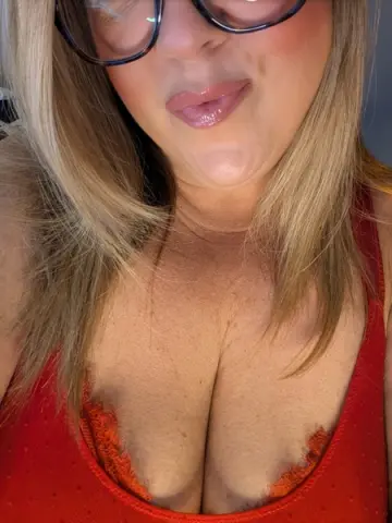 OrlaOnline poses close up, wearing red lingerie that shows her cleavage and blonde hair framing her face.