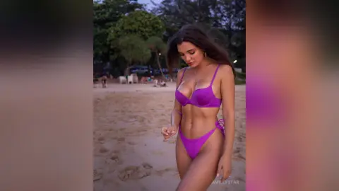 Beautiful woman in a purple bikini posing on a tropical beach at sunset.