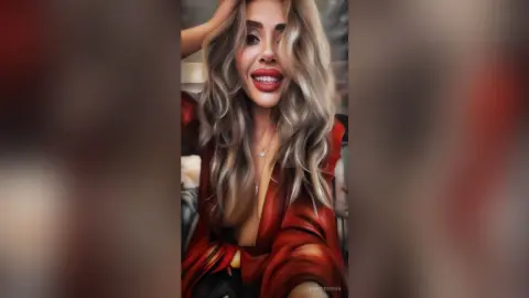 Smiling blonde woman in a red silk blouse posing with a glamorous and confident mood indoors.