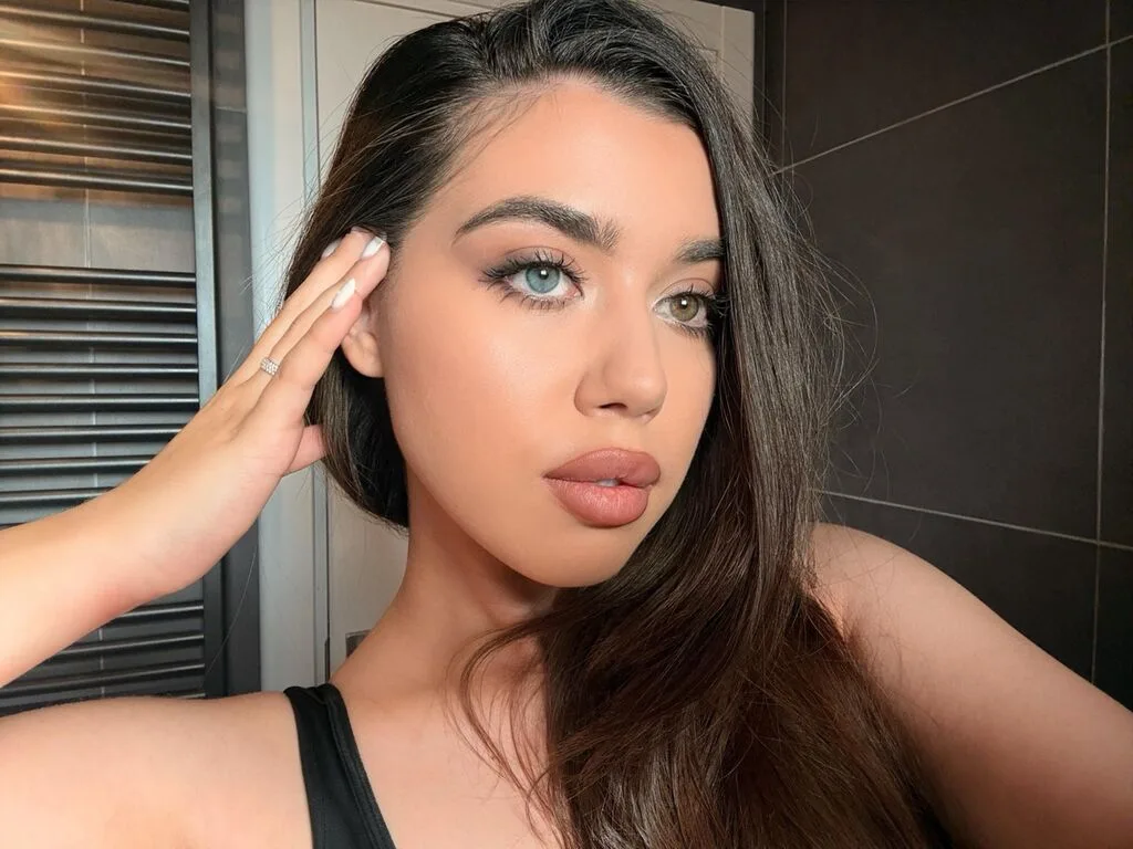 ClaireJenner — ClaireJenner poses for a selfie with her hand in her long brown hair.